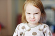 Portrait of little angry toddler girl