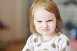 Portrait of little angry toddler girl