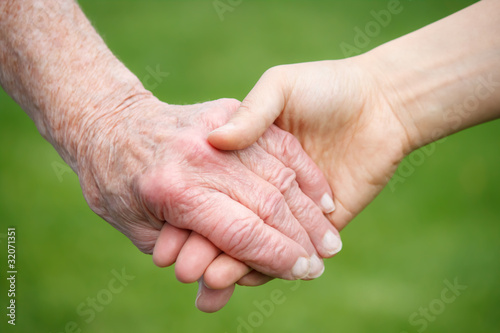 Photo: Senior and Young Women Holding Hands Senior and Young Women Holding Hands