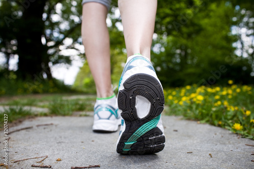 Photo: Woman walking cross country and trail in spring forest Woman walking cross country and trail in spring forest