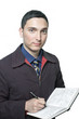 man in jacket and tie writing in his planner isolated on white