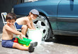 Playing around the car and cleaning, children in summertime