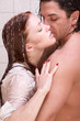 Man and woman in love are kissing in shower