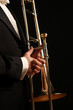 A concert musician holds a trombone
