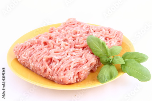 Photo: Raw minced meat on a plate decorated with basil Raw minced meat on a plate decorated with basil