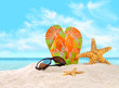 Flip- flops in the sand with starfish