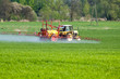 Tractor spraying a field on farm, agriculture Tractor spraying a field on farm, agriculture
