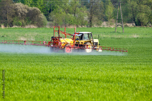 Foto: Tractor spraying a field on farm, agriculture Tractor spraying a field on farm, agriculture