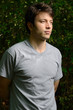 young man with arms folded behind his back