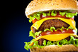 Tasty and appetizing hamburger on a dark blue Tasty and appetizing hamburger on a dark blue