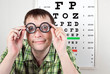 person wearing spectacles in an office at the doctor
