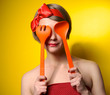 Pinup style housewife with kitchen utensils