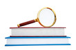 Magnifying glass over the stack of books