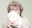 elderly happy woman with pack of money