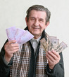 elderly happy man with pack of money