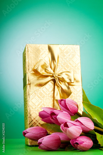 Photo: Celebration concept - gift box and tulip flowers Celebration concept - gift box and tulip flowers