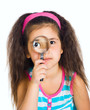 little girl looking through a magnifier