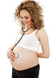 The pregnant woman listens to palpitation of the child