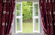 Open window draped in curtains, with a view