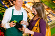 Woman in supermarket and shop assistant