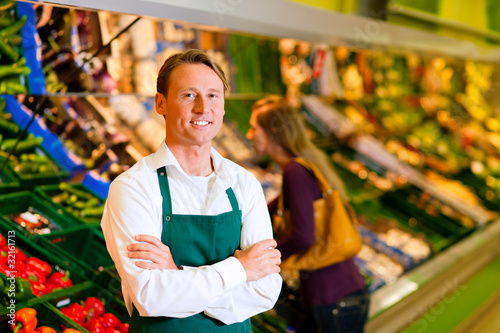 Photo: Man in supermarket as shop assistant Man in supermarket as shop assistant