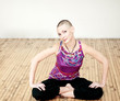 Young woman doing yoga on the floor