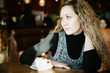 girl with blond curly hair, drinking a cappuccino girl with blond curly hair, drinking a cappuccino
