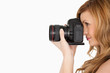Pretty blond-haired woman taking a photo with a camera Pretty blond-haired woman taking a photo with a camera