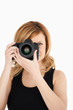 Attractive blond-haired woman taking a photo with a camera Attractive blond-haired woman taking a photo with a camera