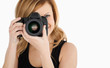 Cute blond-haired woman taking a photo with a camera Cute blond-haired woman taking a photo with a camera