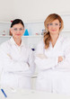 Two female scientists looking at the camera