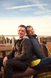 Caucasian young family sitting on log,