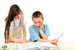 teenage girl and schoolboy on the table with exercise books teenage girl and schoolboy on the table with exercise books