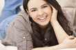 Beautiful Hispanic Woman Laying on Sofa Relaxing & Smiling