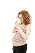 Photo: Adorable young pregnant woman is drinking milk over white Adorable young pregnant woman is drinking milk over white