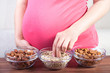 Healthy pregnancy. Pregnant woman eating different seeds Healthy pregnancy. Pregnant woman eating different seeds