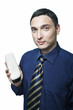 young man in tie holding white shampoo bottle on white