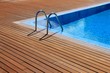 Photo: blue swimming pool with teak wood flooring blue swimming pool with teak wood flooring