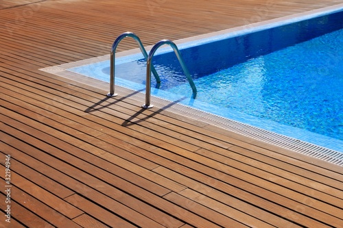 Photo: blue swimming pool with teak wood flooring blue swimming pool with teak wood flooring