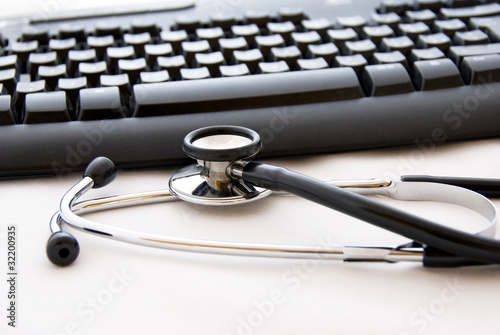 Photo: A stethoscope and computer keyboard A stethoscope and computer keyboard