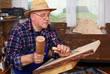 Photo: Woodcarver work in his workshop Woodcarver work in his workshop