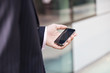 A businessman looking at a map on his mobile phone