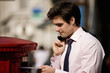A businessman posting letters in a letterbox