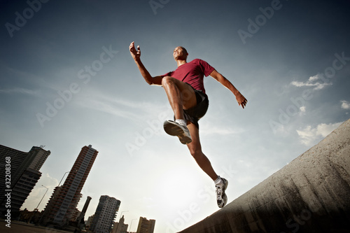 Photo: hispanic man running and jumping from a wall hispanic man running and jumping from a wall