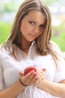 Photo: Beautiful smiling woman holding apple Beautiful smiling woman holding apple