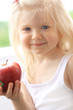 Photo: Beautiful smiling girl holding apple Beautiful smiling girl holding apple