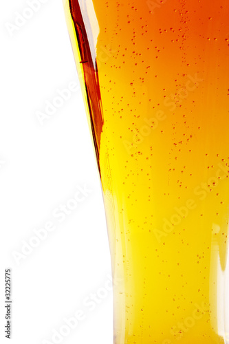 Photo: Detail of glass of beer, isolated on white background Detail of glass of beer, isolated on white background