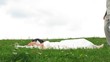 Newlywed pair poses for photographer on grass, time lapse Newlywed pair poses for photographer on grass, time lapse