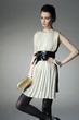 fashion model holding little purse in light background fashion model holding little purse in light background