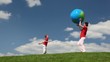mother and son playing inflatable ball on meadow